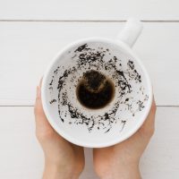 top-view-hands-holding-coffee-cup